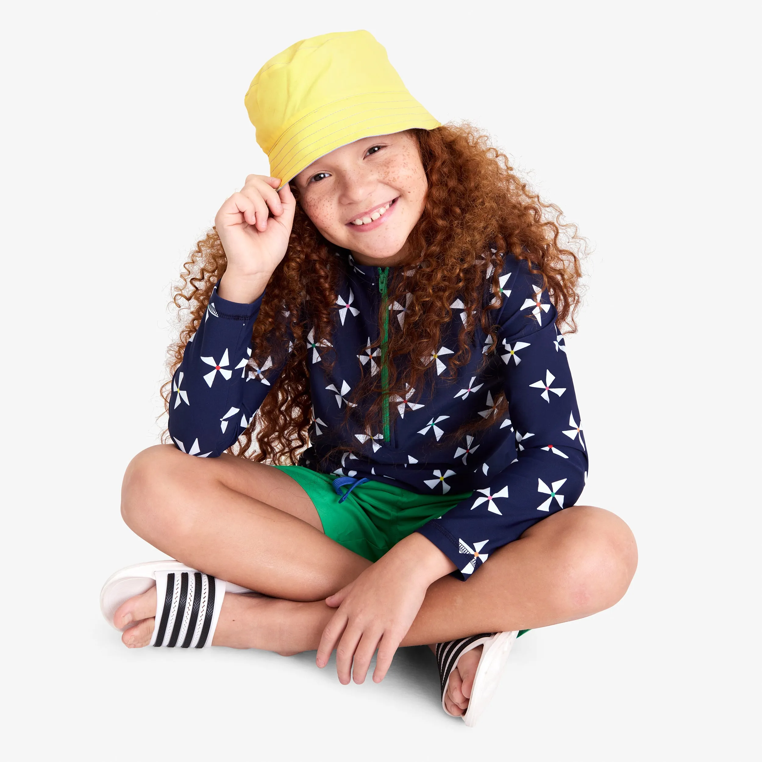 Long sleeve half-zip rash guard in rainbow pinwheels